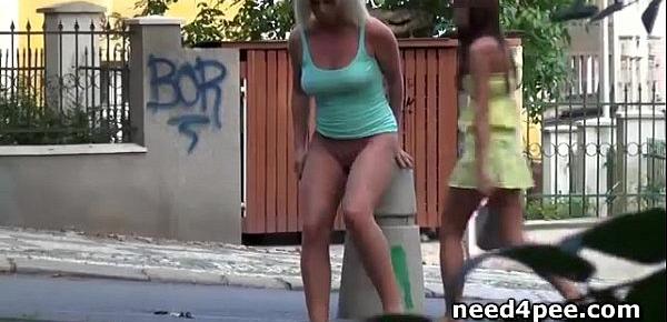  Tanned blonde pisses standing on the side walk